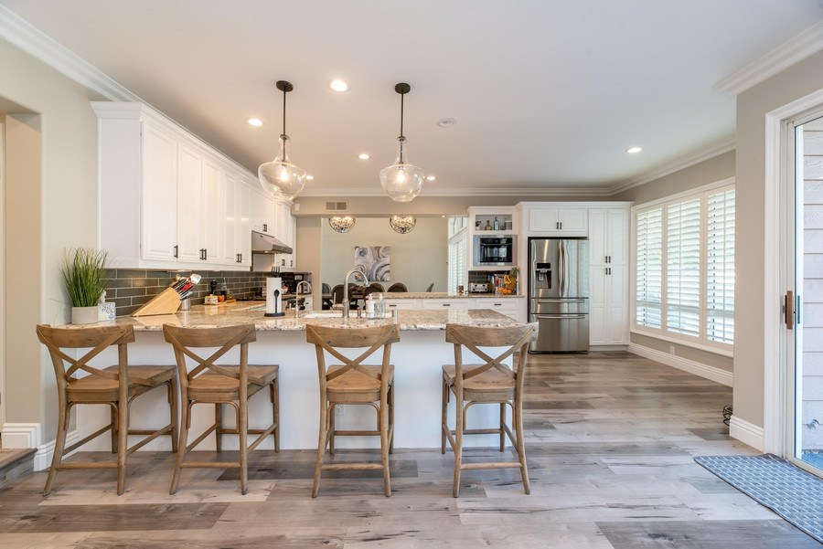 kitchen with wooden chairs and lighting system.