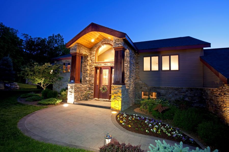 Entryway and pathway lights illuminating a home at dusk.