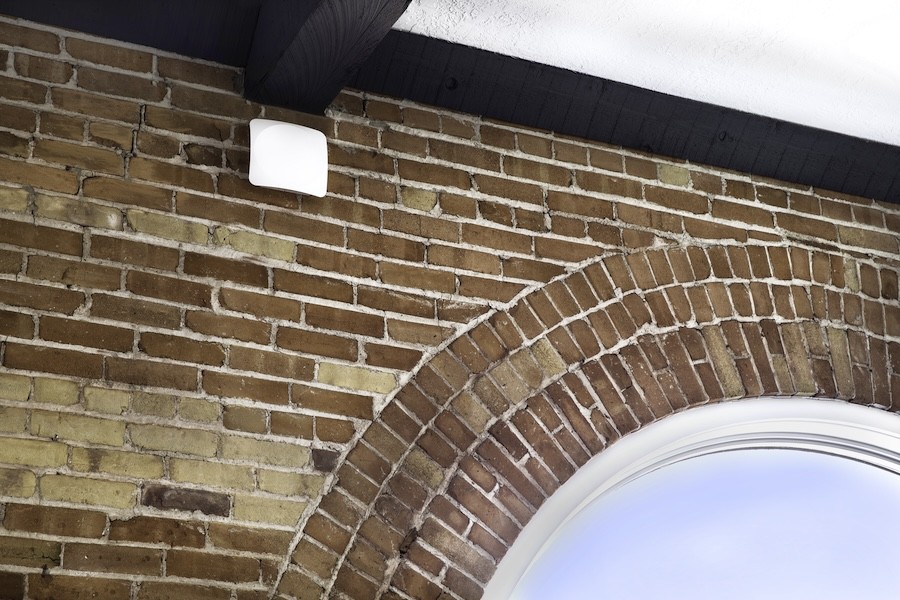 A Wi-Fi router installer high on a wall.