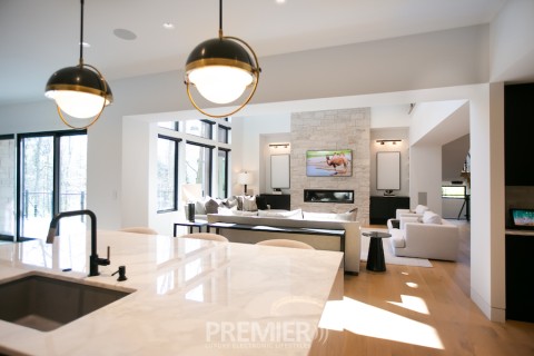 An open living space featuring in-ceiling whole-home audio speakers.