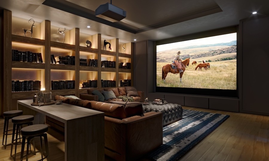 A home theater with leather furniture and a large screen with Sony projector.